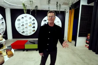 Stohl András sneakerek előtt mutogatva vidáman beszél.